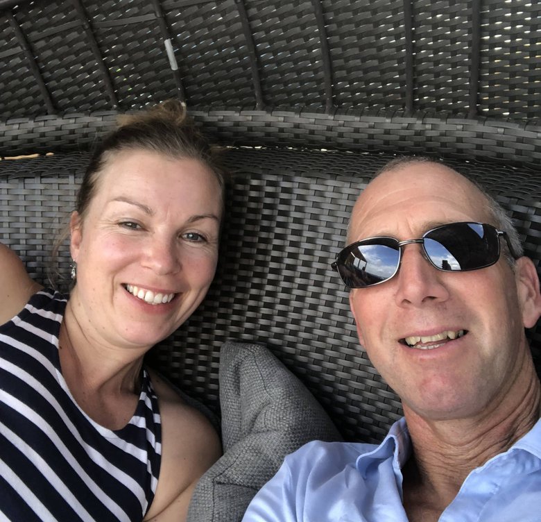 Greg and Carola Tibben relaxing on woven outdoor furniture